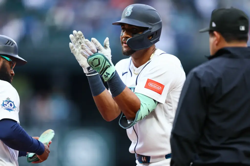 The Seattle Mariners’ Julio RodrÃ­guez, center, celebrates after hitting a...