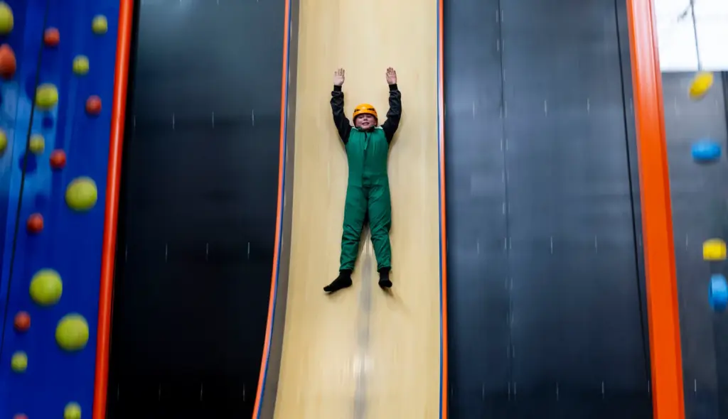 Alexander Rodas slides down a giant slide in Sender City...