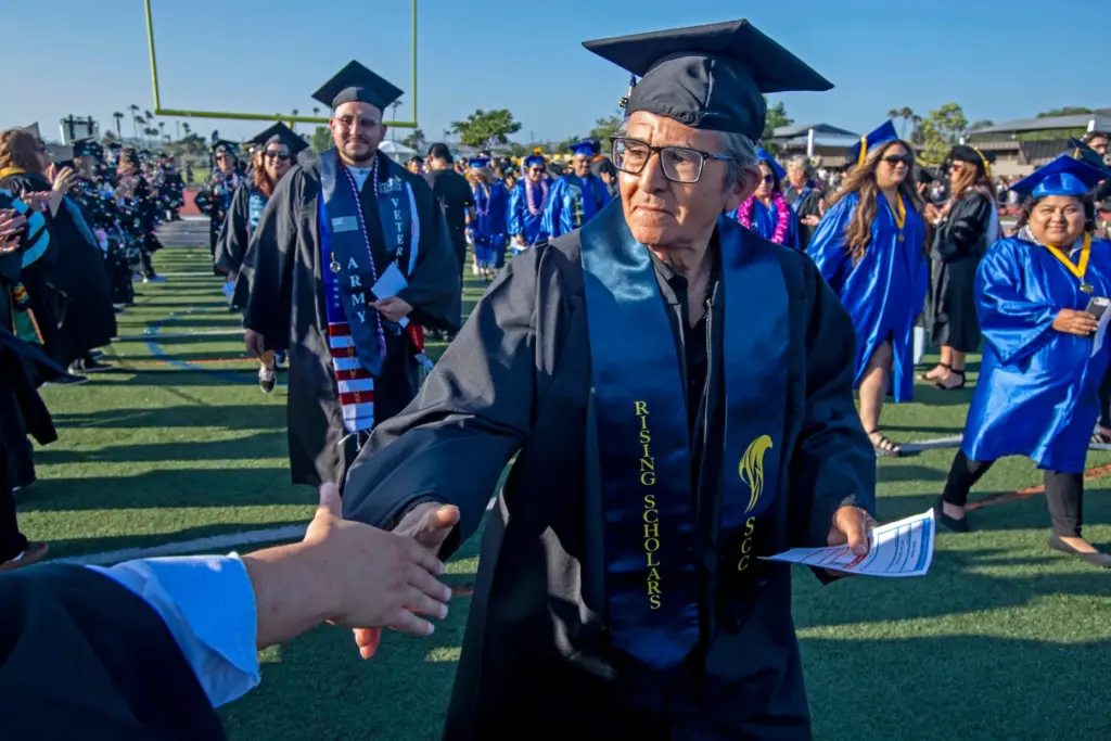 Graduates were welcomed and congratulated by faculty on their way...