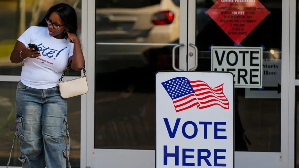 A woman leaves a voting center after voting, Tuesday, May...