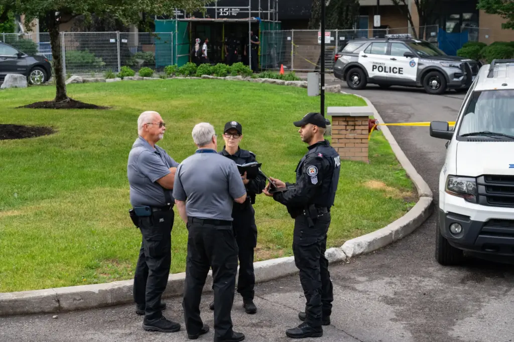 Investigators work the scene where a Toronto Police officer was...