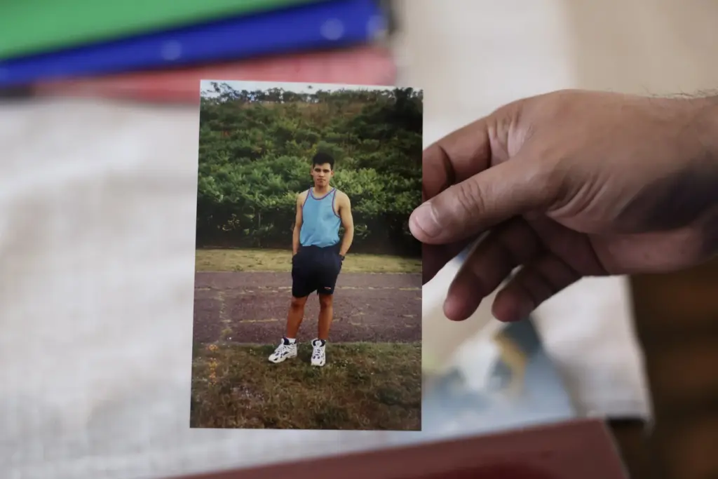 Jose Palma holds a photograph of himself when he moved...