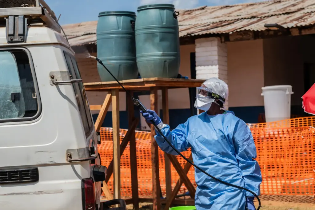 A health worker disinfects an ambulance at the Mongbwalu treatment center.