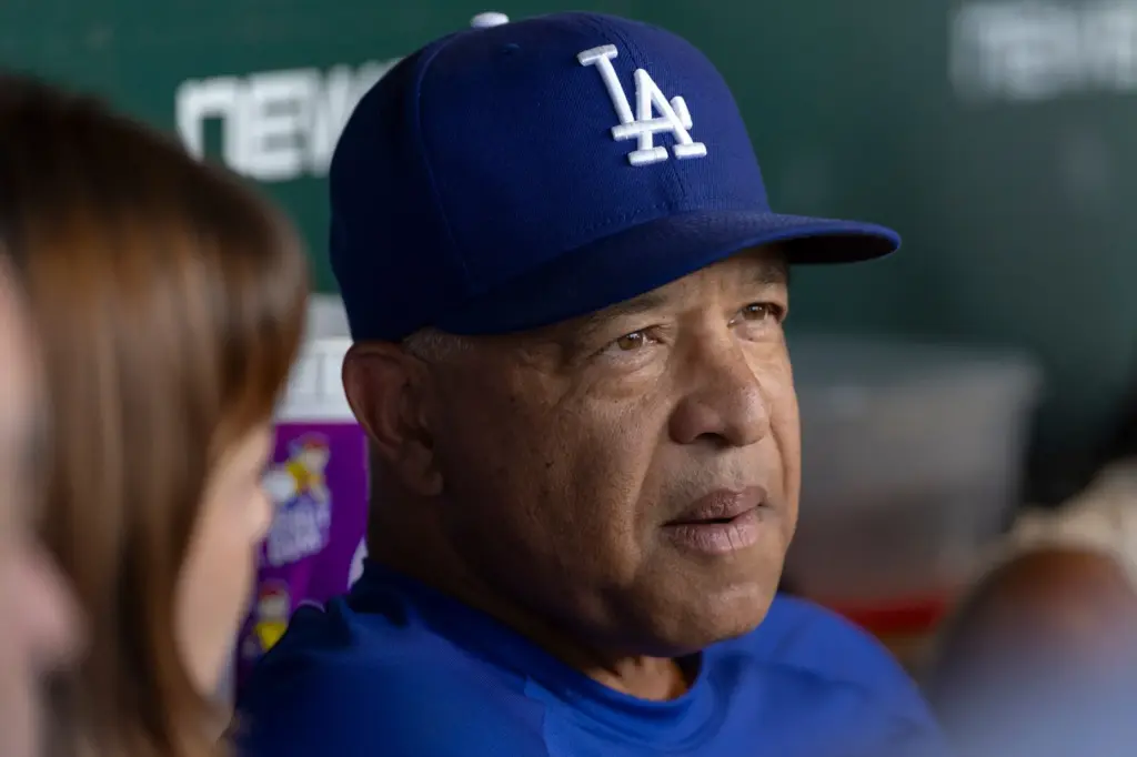 Dodgers manager Dave Roberts speaks with reporters before a game...