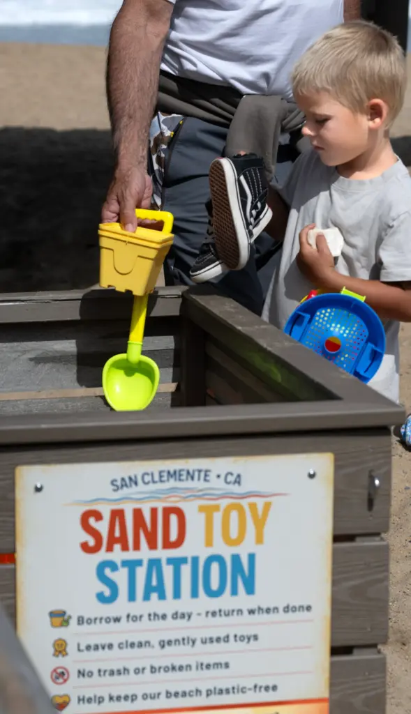 Four-year-old Warner Allen returns plastic toys at a Sand Toy...