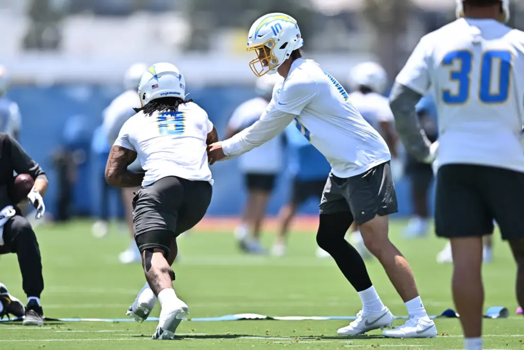 Chargers quarterback Justin Herbert, center right, and running back Omarion...