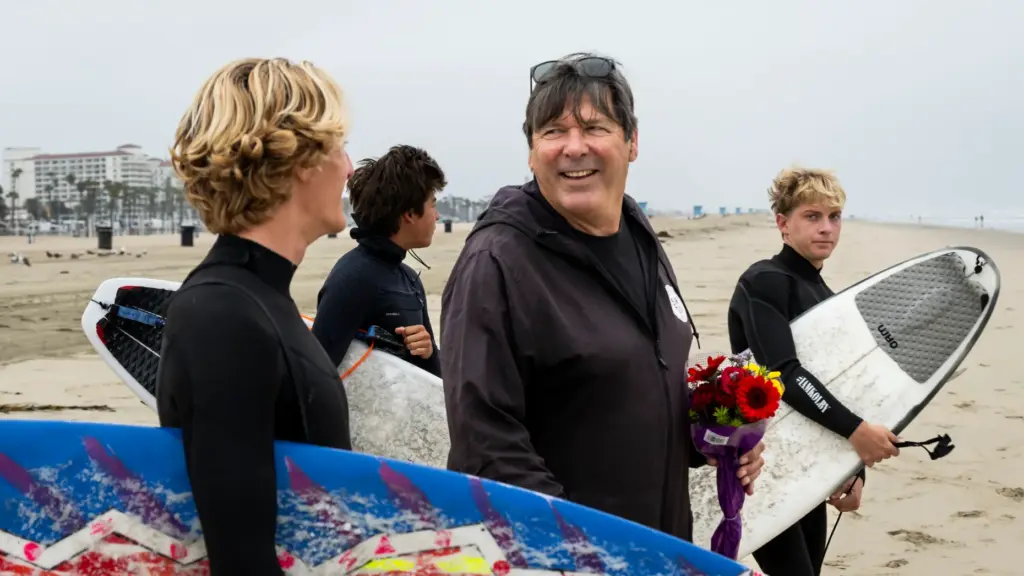 Huntington Beach High School surf team members Dylan Sloan laughs...