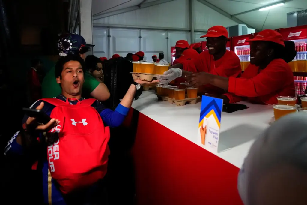 A man buys beers at a fan zone ahead of the FIFA World Cup.