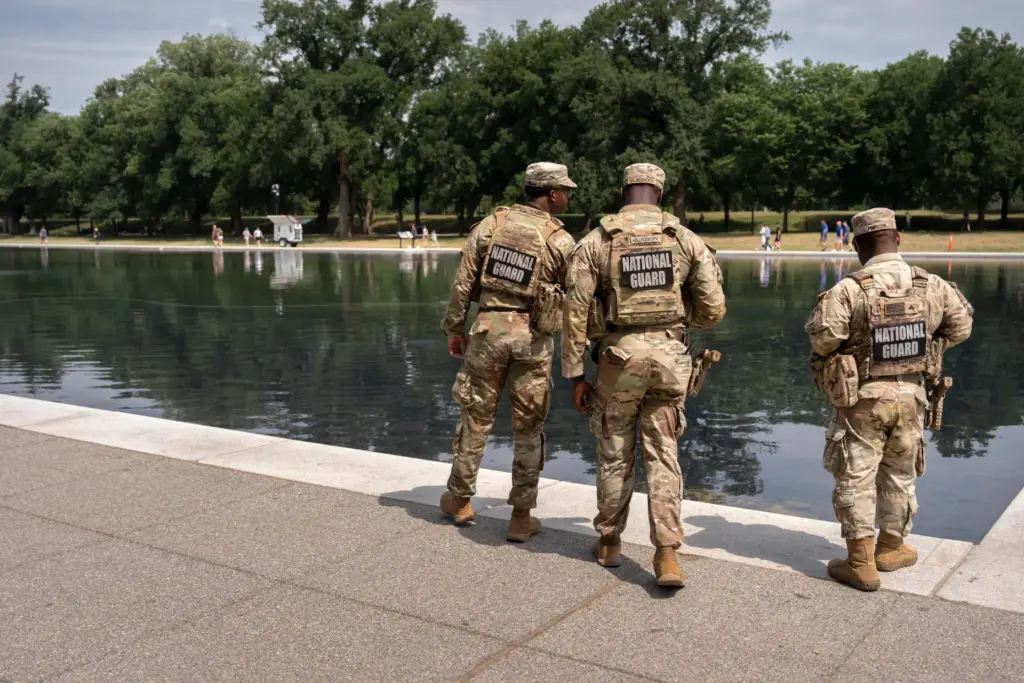 National Guard members look at the Lincoln Memorial Reflecting Pool,...