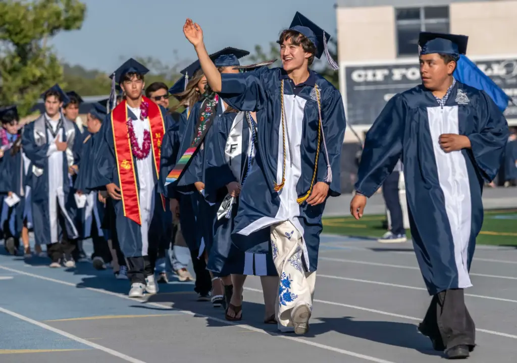 Members of Trabuco Hills High Schoolâs class of 2026 wave...