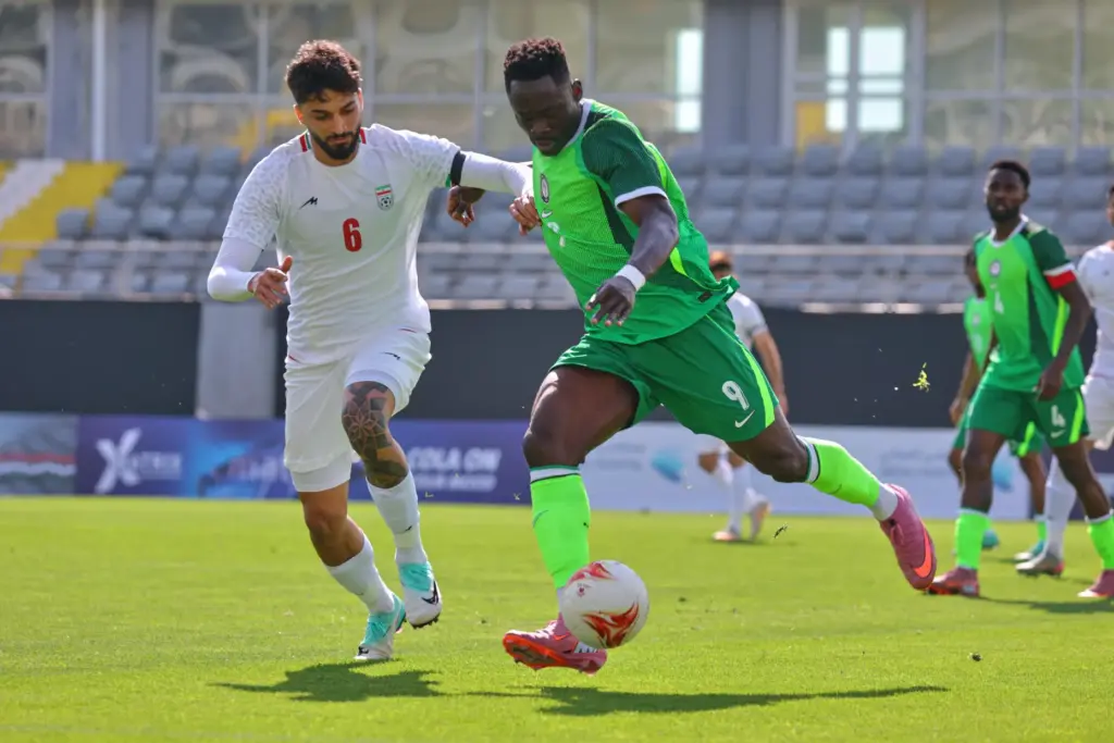 FILE – Nigeria’s Akor Adams, right, fights for the ball...