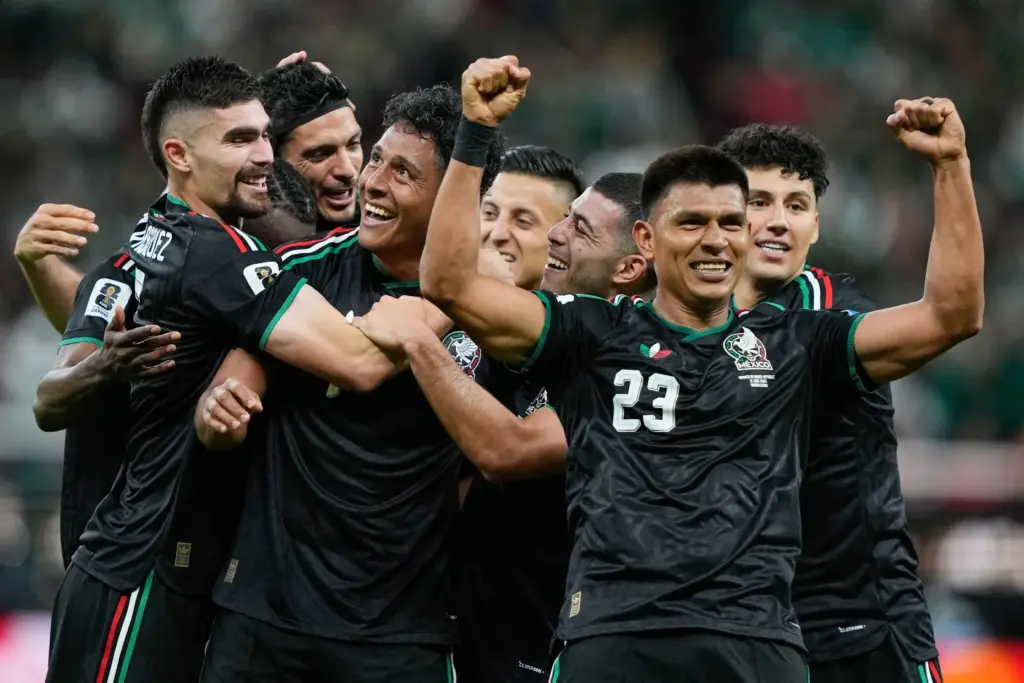 Mexico’s Luis Romo, third left, celebrates with his teammates after...