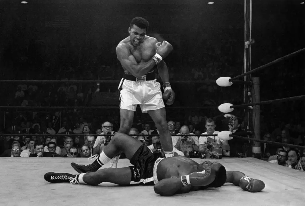 FILE – Heavyweight champion Muhammad Ali stands over fallen challenger...