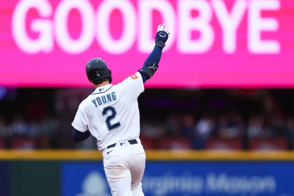 The Seattle Mariners’ Cole Young celebrates as he runs the...