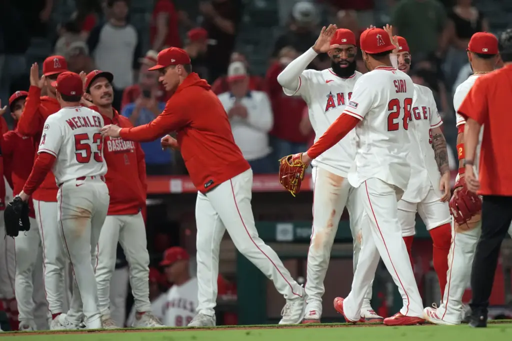 The Angels’ Jo Adell (7) high-fives fellow outfielder Jose Siri...