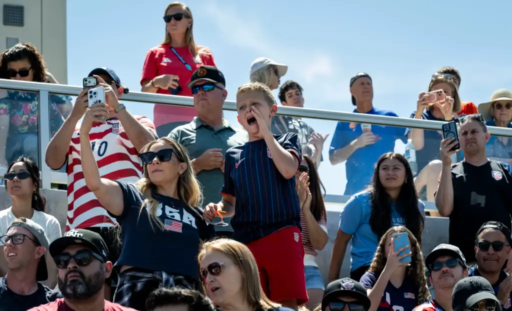 Fans cheer for the U.S. Menâs National Team as they...
