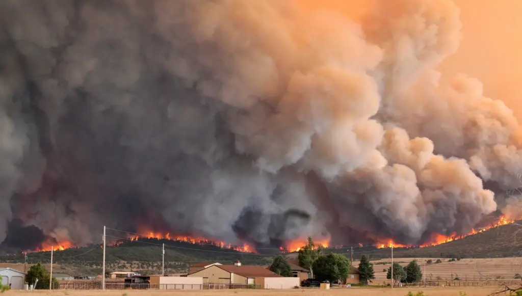 The Aspen Acres fire engulfs a hillside near Beulah, Colo.,...