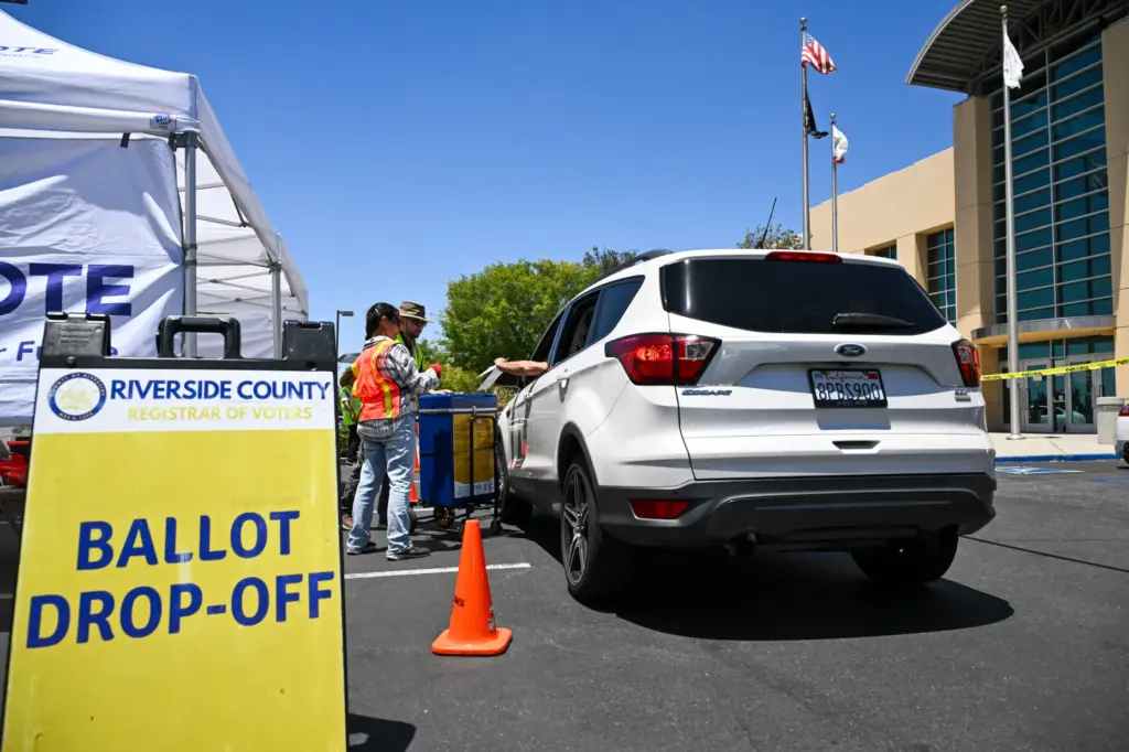 A drive-through ballot drop-off station is set up Monday, June...