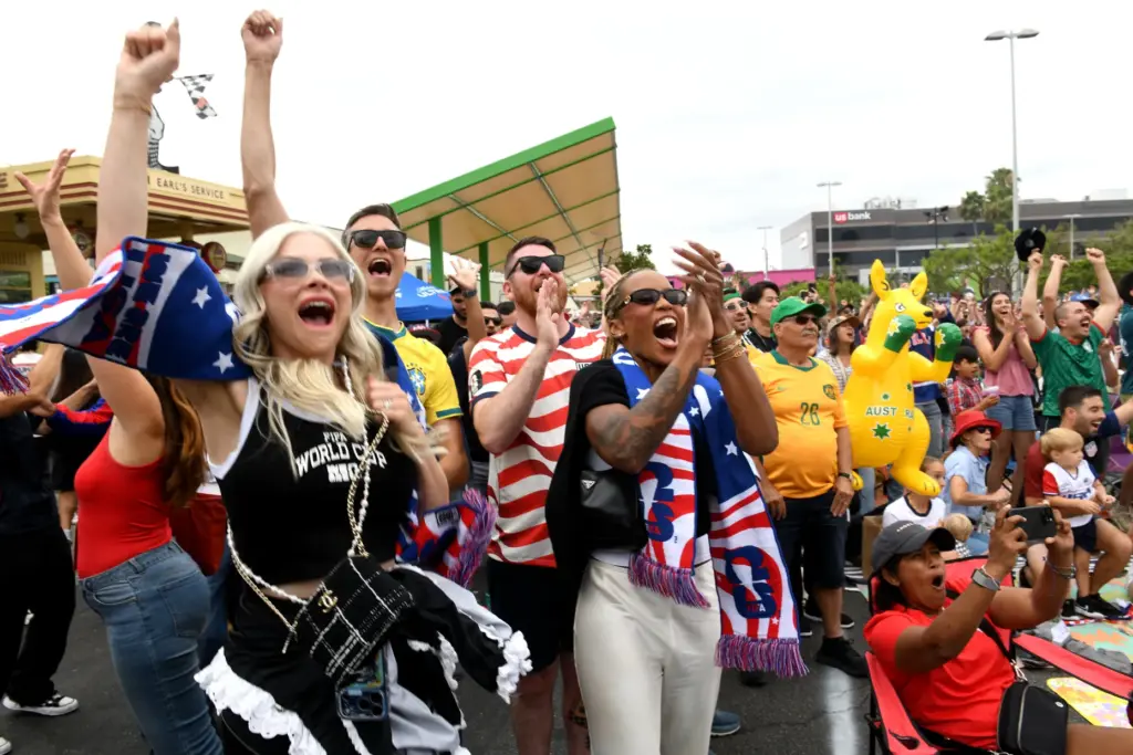 Jennifer Panosso, left, and Sabrina Bias cheer an American goal...