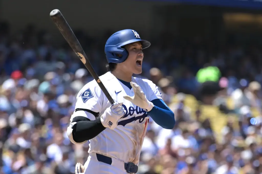 Dodgers’ Shohei Ohtani reacts after hitting a foul ball during...