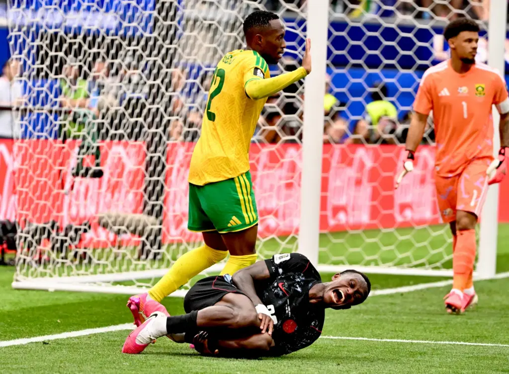 Canada defender Richie Laryea (22) grimaces in pain after being...