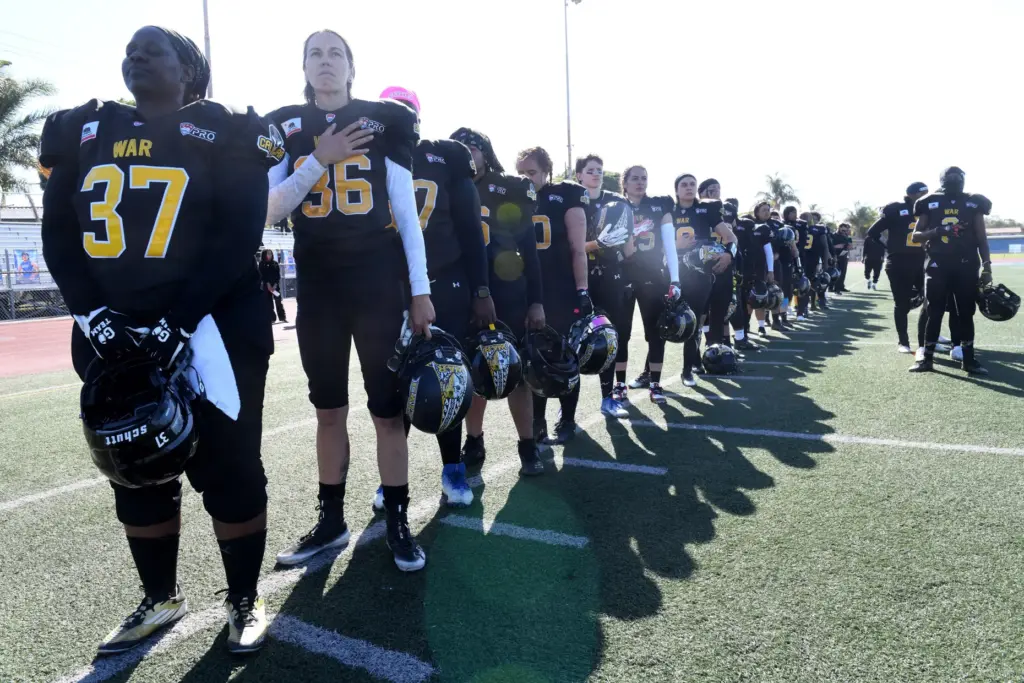 Cali War team members line up for the national anthem...
