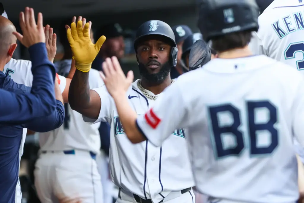 The Seattle Mariners’ Randy Arozarena, center, celebrates in the dugout...