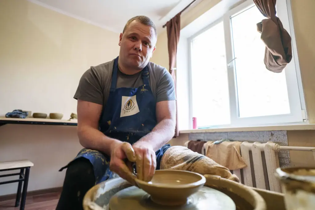 Ivan Shostak, a blind Ukrainian war veteran makes a clay...