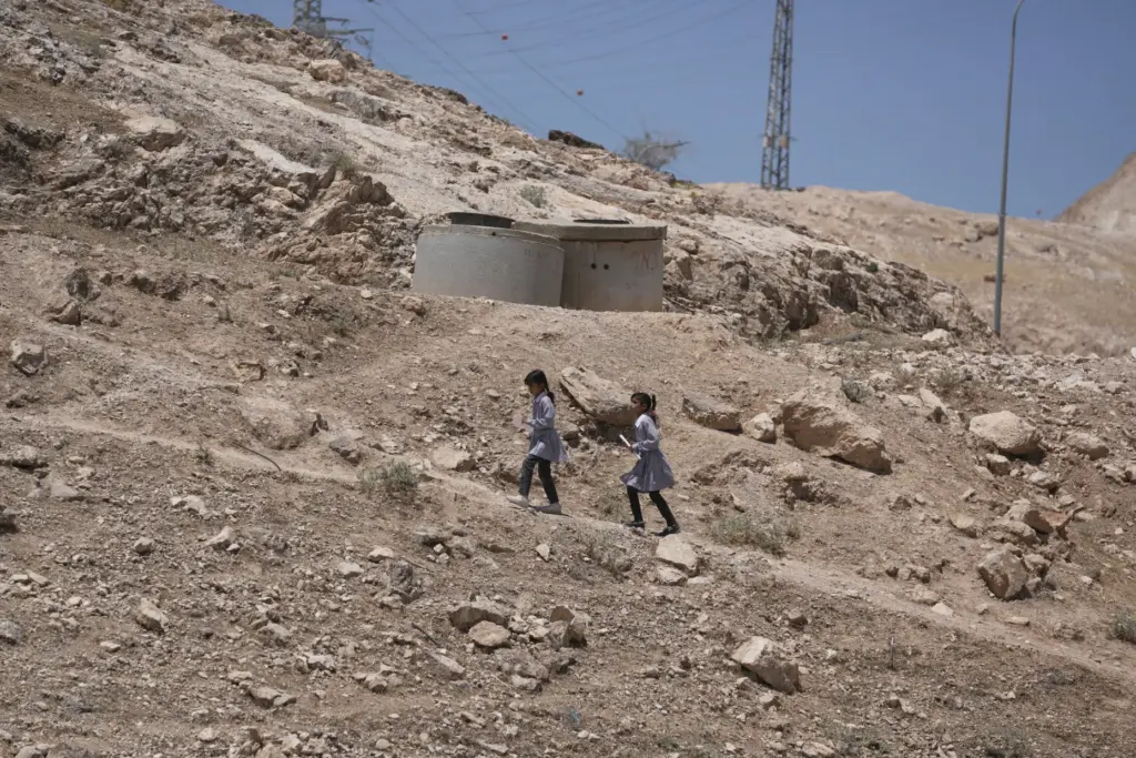 Palestinian students walk on their way home after receiving their year-end reports.