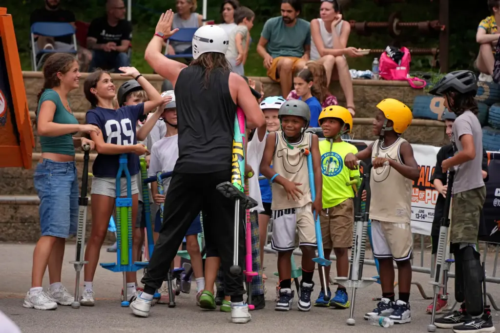 Extreme pogo athlete Harry White of Ontario, Canada, greets young...