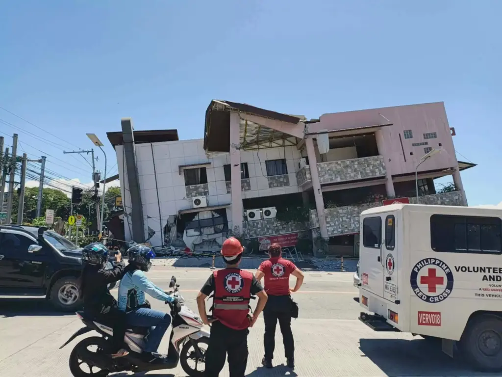 In this photo provided by the Philippine Red Cross, rescuers...