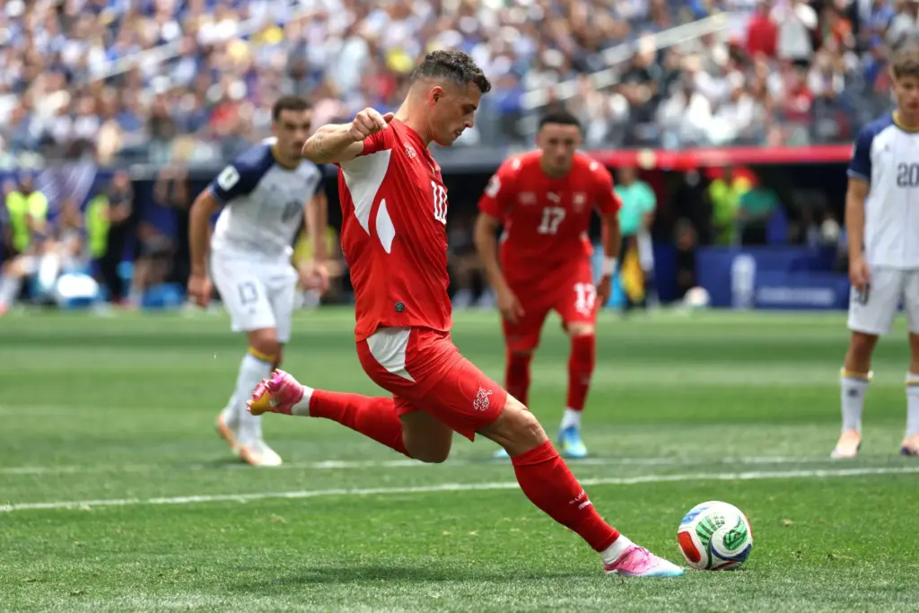 Switzerland midfielder Granit Xhaka (10) converts a penalty kick for...