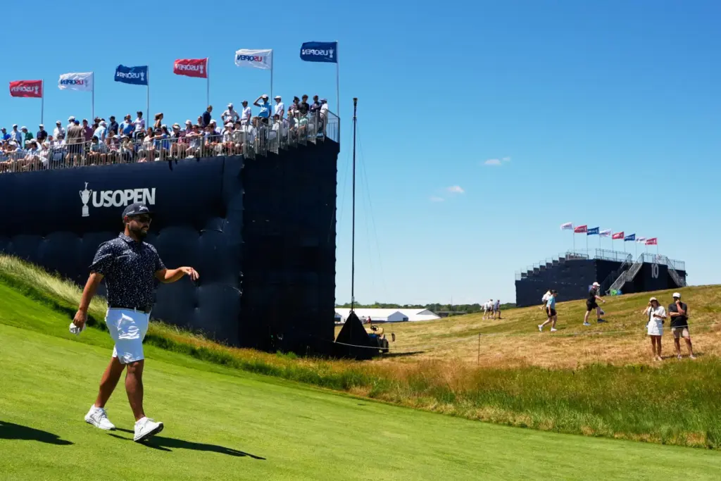 J.J. Spaun walks to green on the 12th hole during...