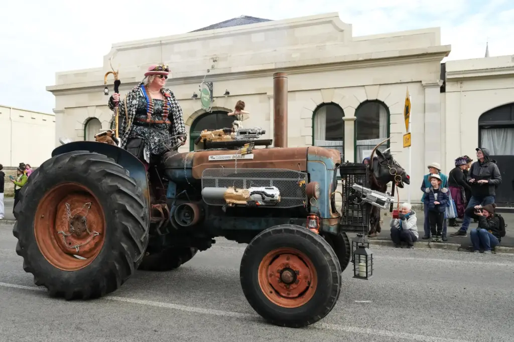 A participant rides a tractor during a parade at the...