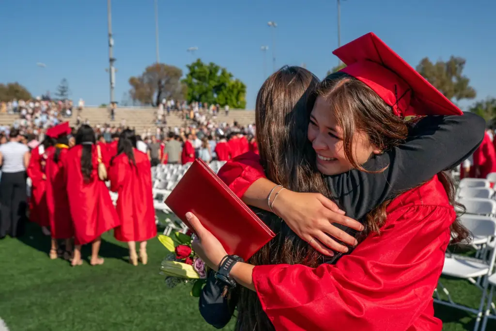Sarah Wilbur, left, hugs her sister Hannah Wilbur following the...