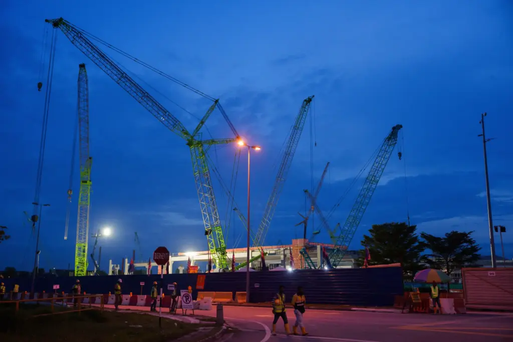 Workers walk outside a data center building under construction.