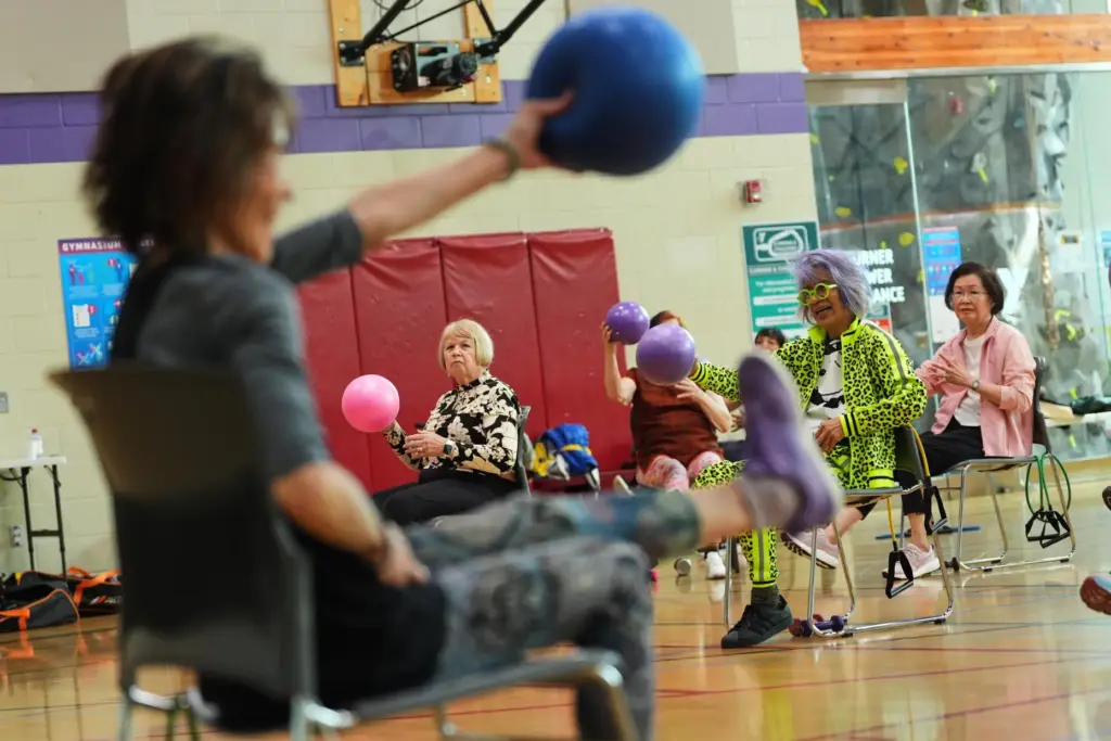 Instructor Bengie Santos, 72, leads a class for older adults.