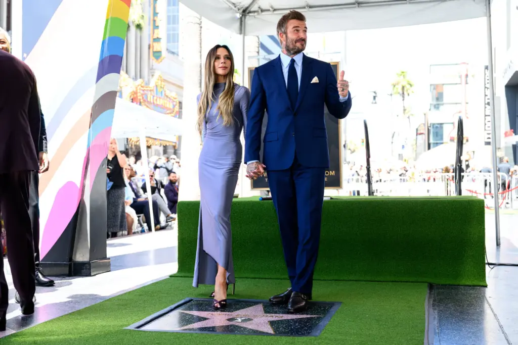 David and Victoria Beckham pose at his Hollywood Walk of...