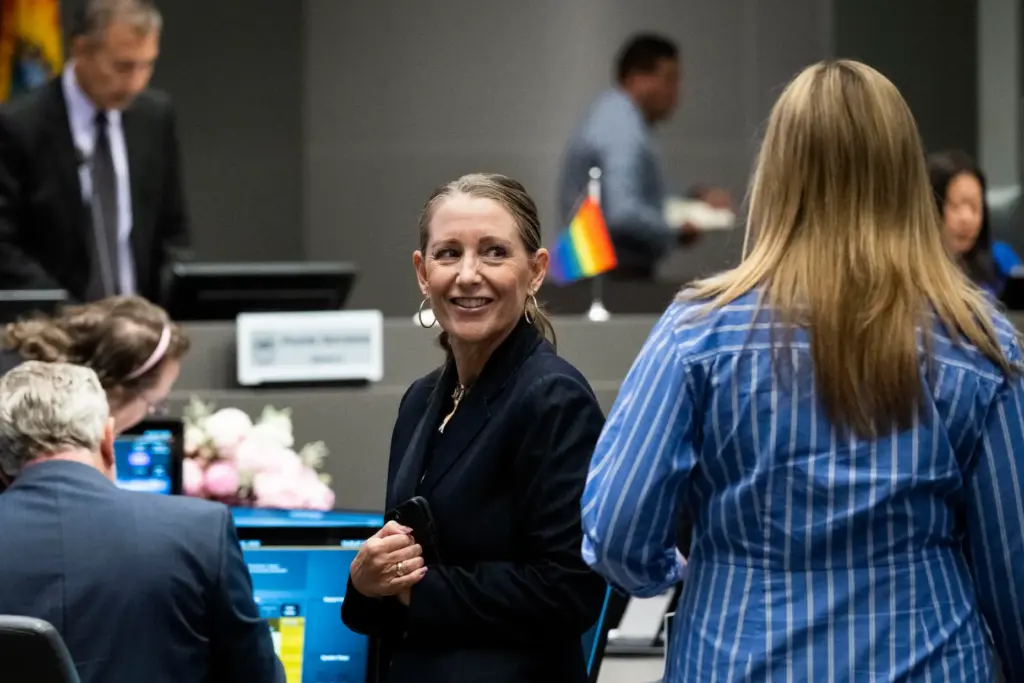 CEO Michelle Aguirre talks to a colleague before the OC...