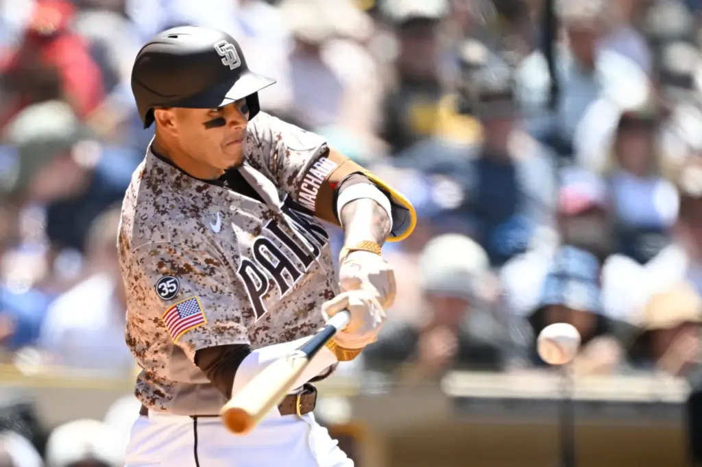 San Diego Padres’ Manny Machado (13) hits a solo home...