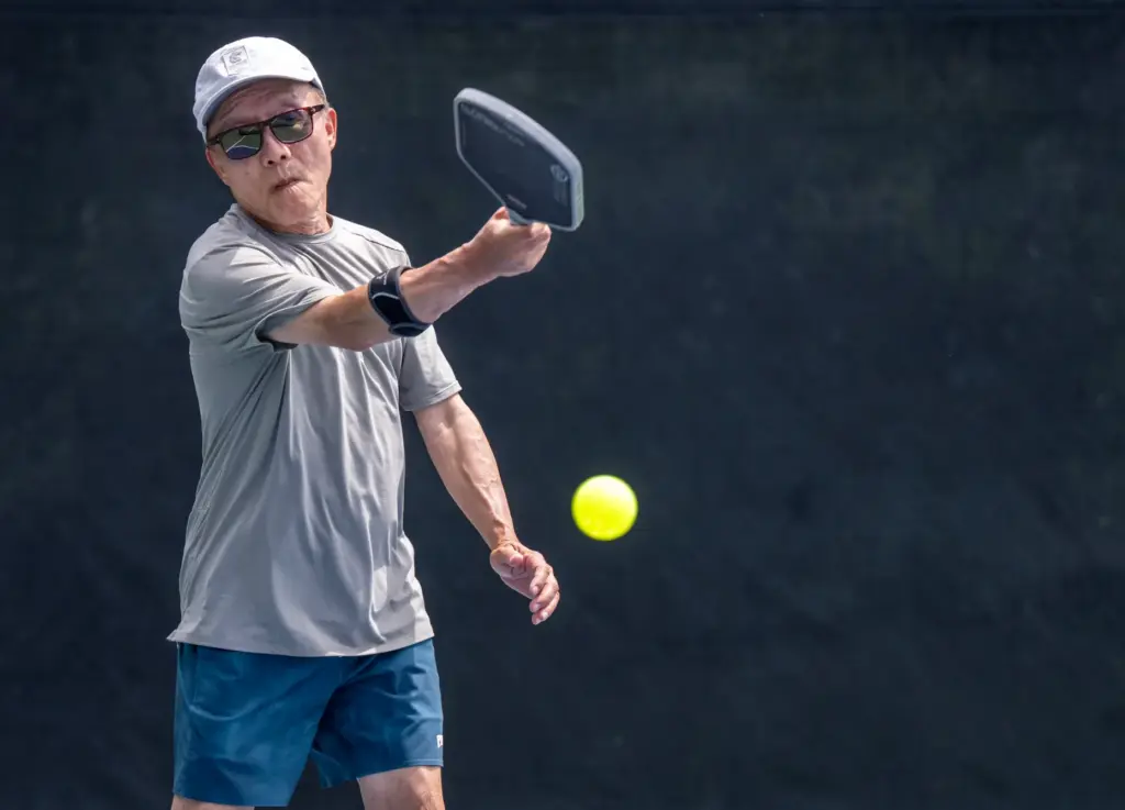 Joseph Tseng of Mission Viejo serves while competing in the...