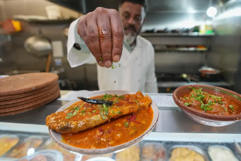 Chef Mohammed Shanoor Ali prepares food at a Bangladeshi restaurant...