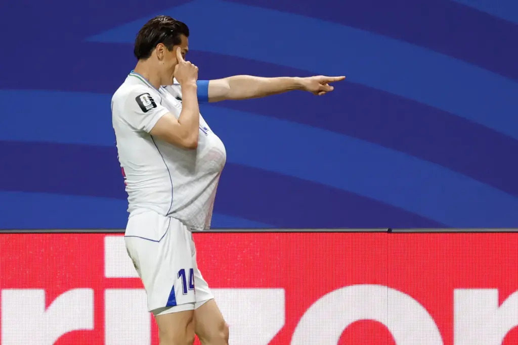 Uzbekistan’s Eldor Shomurodov (14) celebrates after scoring their first goal...