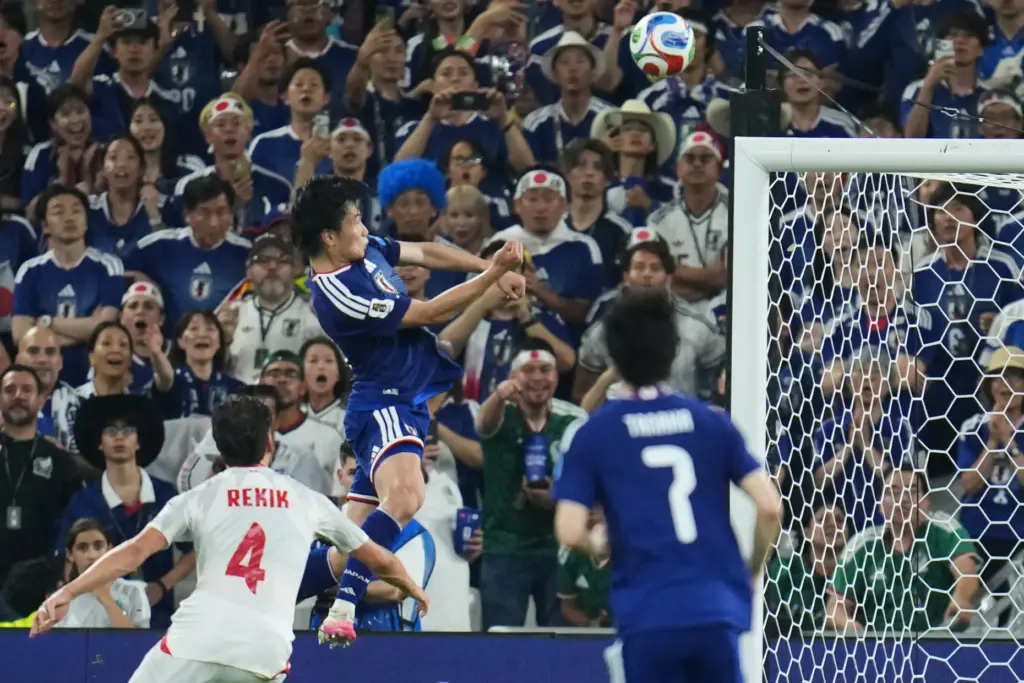 Japan’s Ayase Ueda, center, scores their fourth goal with a...