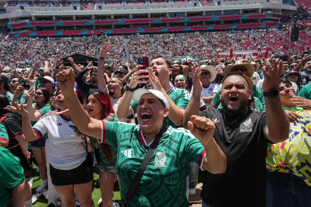 Fans react while watching a live broadcast of the World...