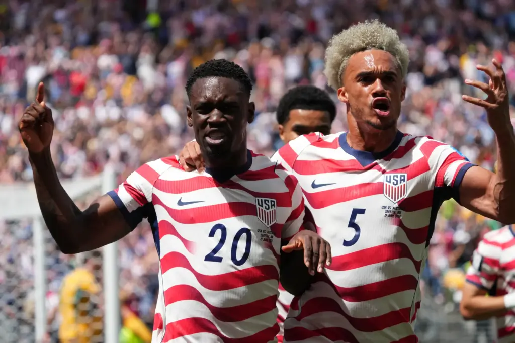 United States’ Folarin Balogun (20) and Antonee Robinson (5) celebrate...