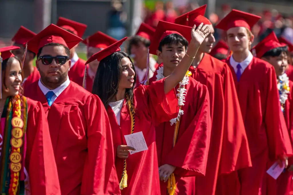 Woodbridge High School senior Delara Mirdamadi, waves to her family...