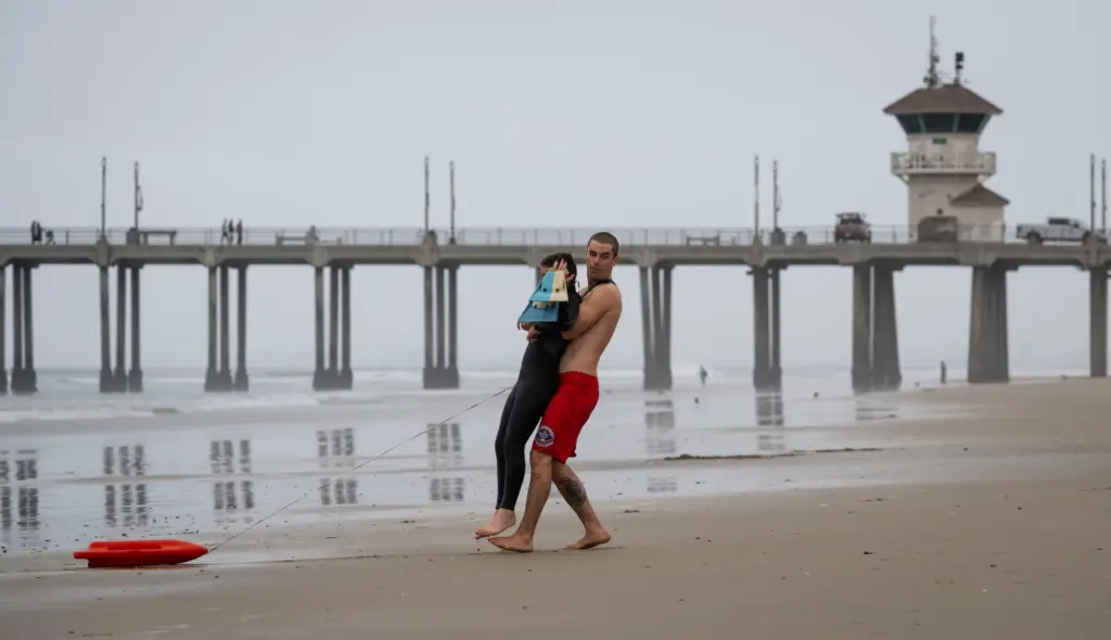 Lifeguard Riley Sterzer simulates a rescue of Kyle Costa, 11,...