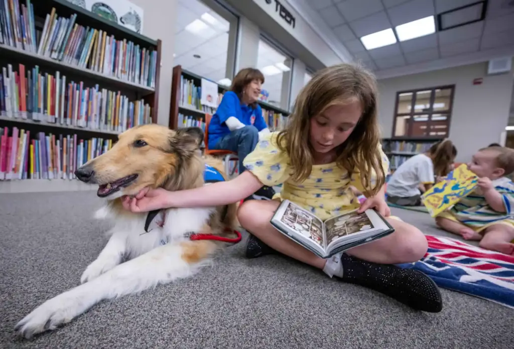 Chloe, 10, of Ladera Ranch, a third grader, pets Lido,...