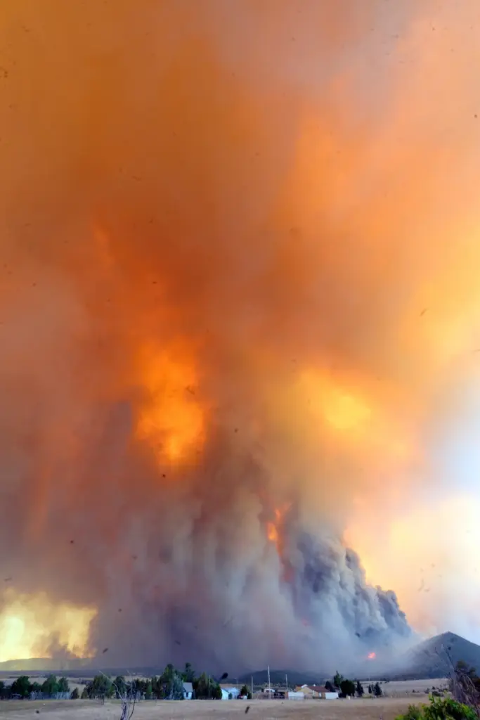 The Aspen Acres fire engulfs a hillside near Beulah, Colo.,...